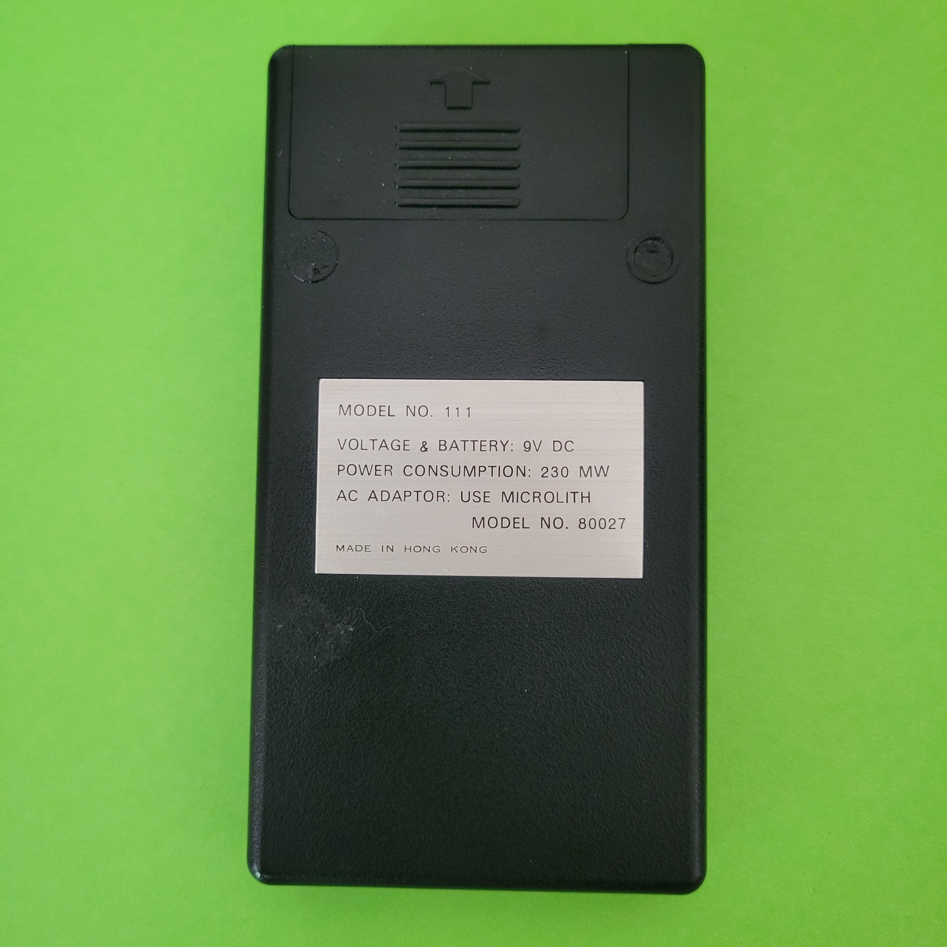 An image of the back of a Microlith Four function plus calculator